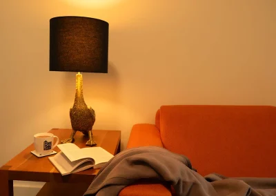 photo of couch with lamp and coffee table