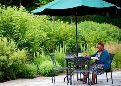patio at Prospect Street with guest sitting at table writing