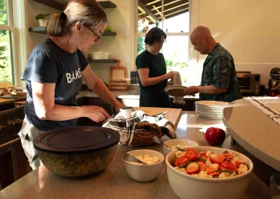Amy, V, and Alice working in kitchen