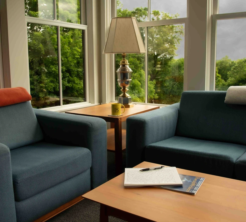 Interior room with couch, chair, table, and windows