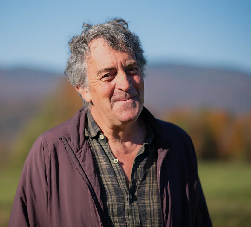 Gary Clark posing for photo with trees and mountains in background