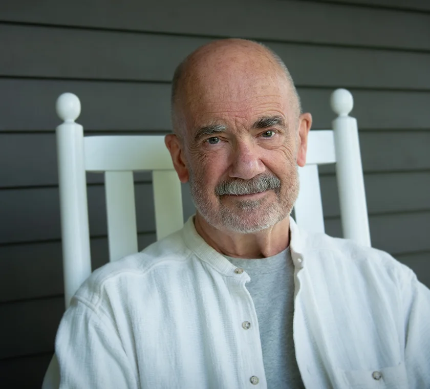 V. Hansmann sitting in chair on front porch